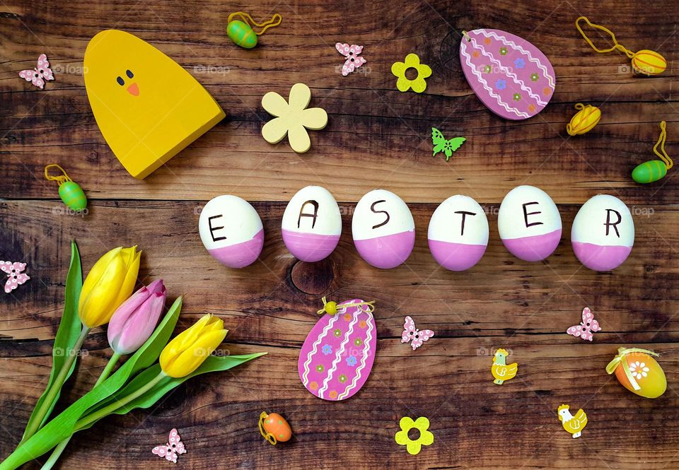 Overhead top  view of easter decorations and word easter spelled on eggs