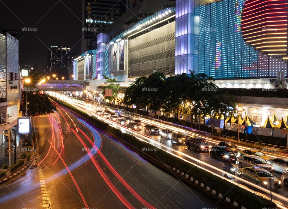 Beautiful Vehicle headlamp light at U turn road in front of the most famous shopping center MBK , Bangkok Thailand