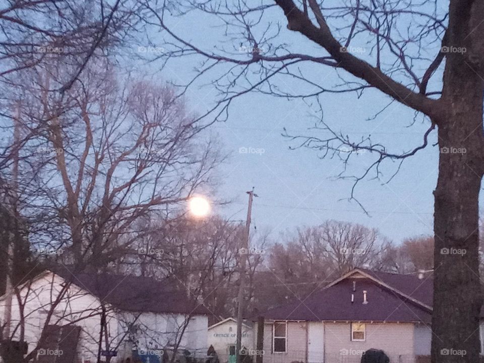 the Wolf moon showing it's face before the sun goes to sleep. there's beauty all around