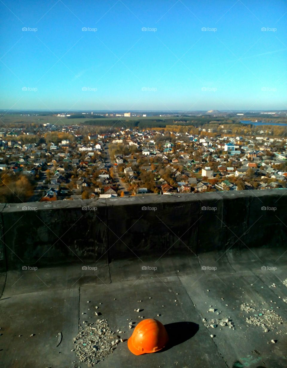 orange helmet of the builder and the view from the roof