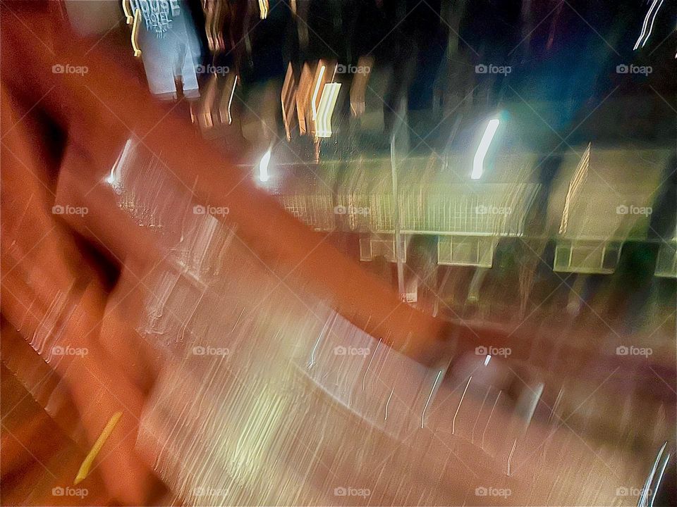 Bright lights are appearing through the blur on an early December 2023 evening at “Newtown Creek” seen from the “Pulaski Bridge” on the “Greenpoint”, Brooklyn side. Hypnotic Productions