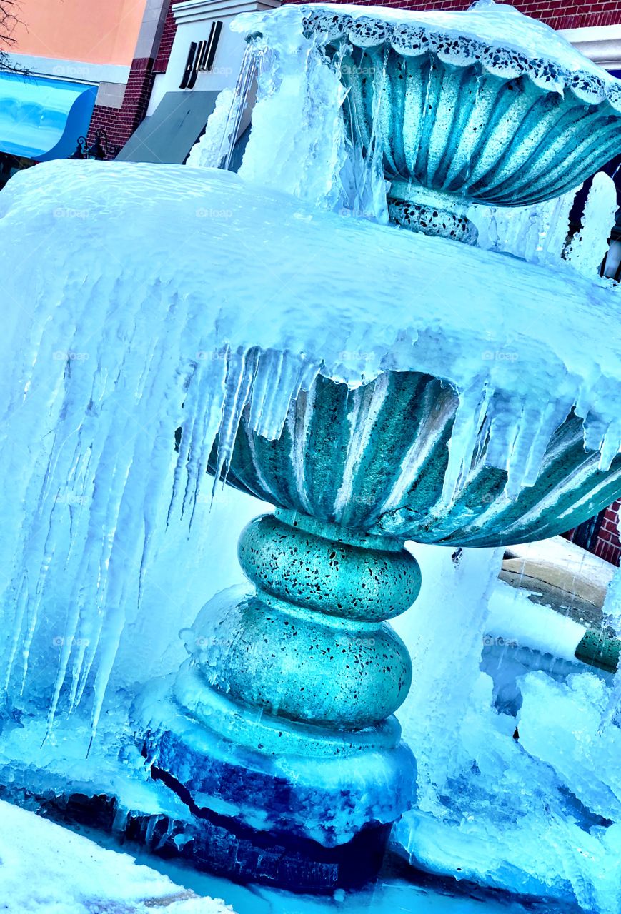 A frozen wonderland with a frozen fountain in winter 