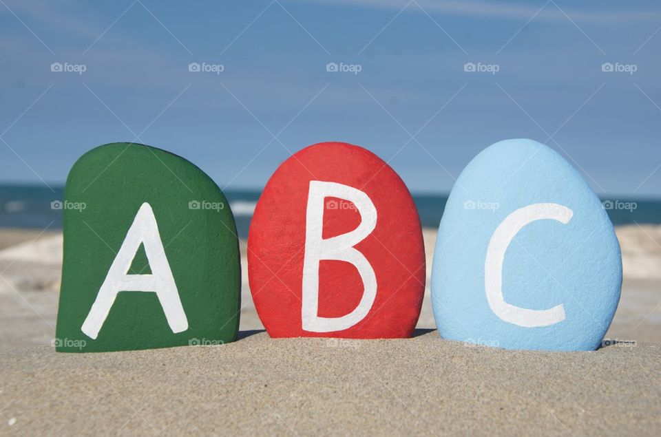 ABC on stones, letters on the sand