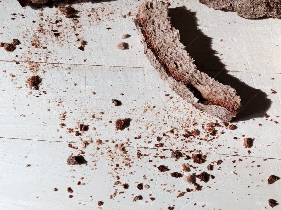 Bread crusts on wooden chopping board 