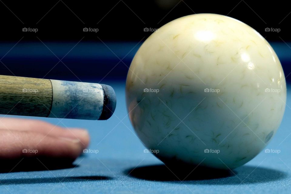 Foap, The Most Popular Sports in the USA: Closeup of the top of the cue stick and the cue ball. 
