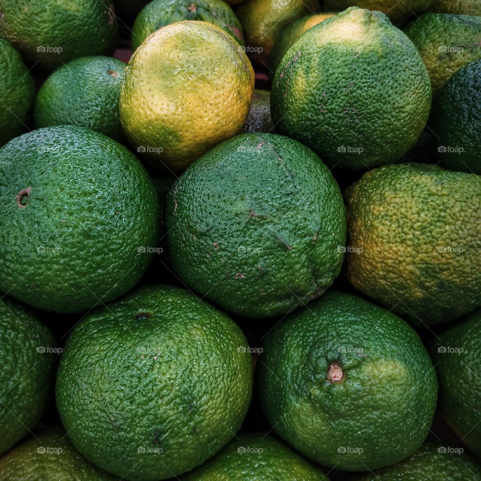 Close-up of green limes for sale in market