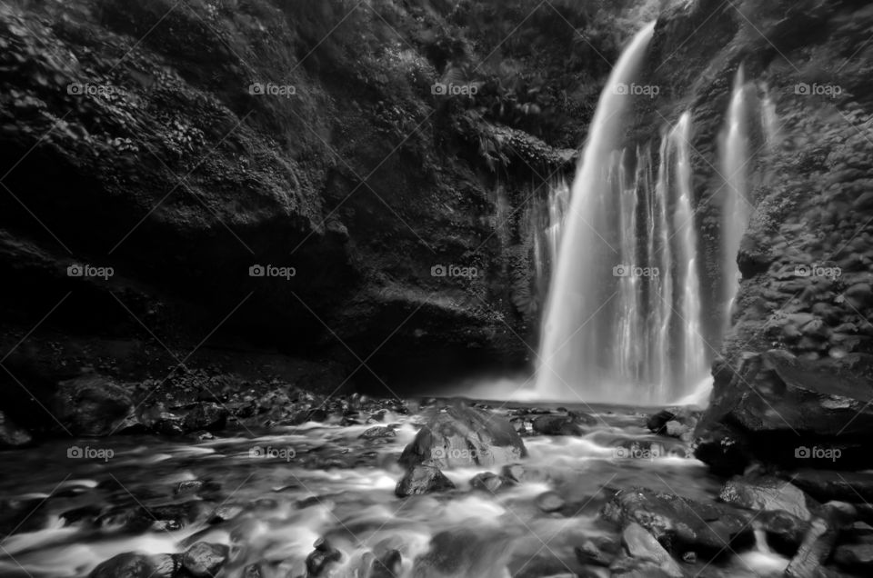 Amazing fine art black and white Tiu Kelep Waterfall near Rinjani, Senaru Lombok indonesia. Southeast Asia. Motion blur and soft focus due to Long Exposure Shot.