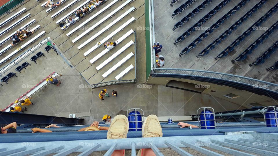 A view from above as people enter a city ballpark.