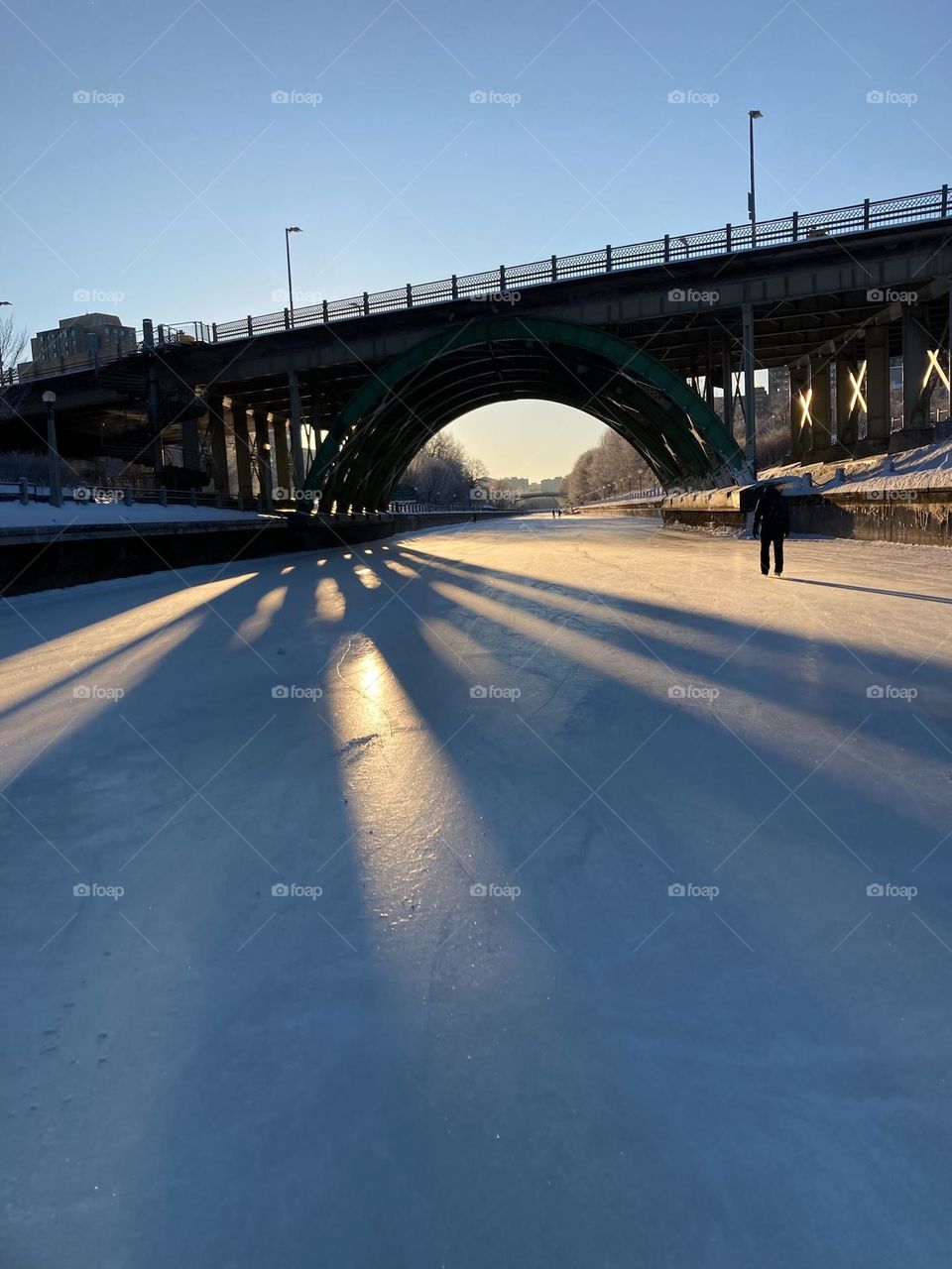 Sunrise behind The Mackenzie King bridge from the Rideau Canal Skateway, Ottawa, Canada.