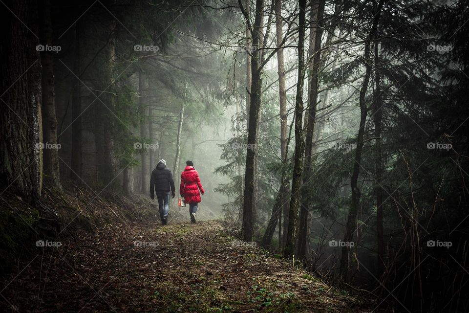 Two lovely couple enjoying their time in nature while hiking together in the forest.