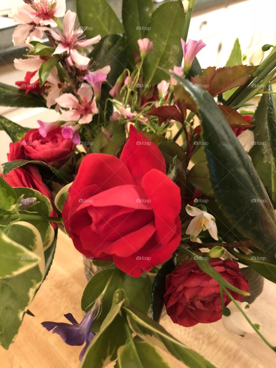 A vase of a variety of colorful reds, pink, lavender and white flowers  I picked out of my winter southern garden.
