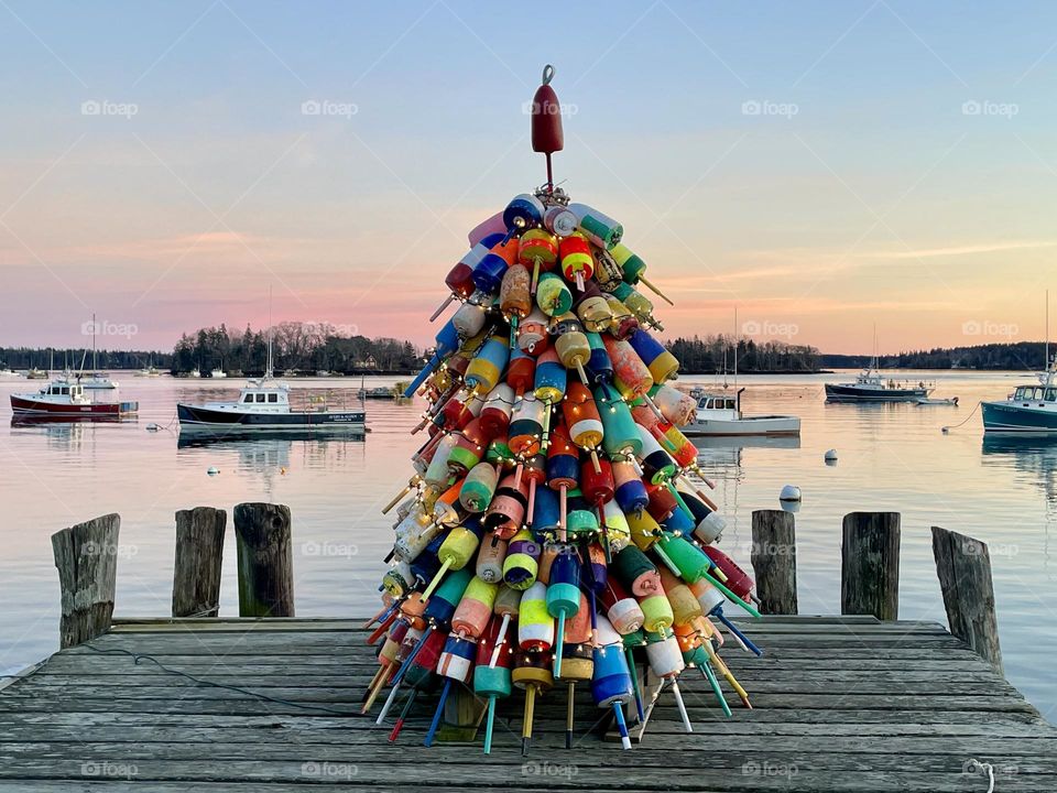 A Christmas tree made of pot buoys sits at the end of a wharf in Friendship Harbor, Maine.