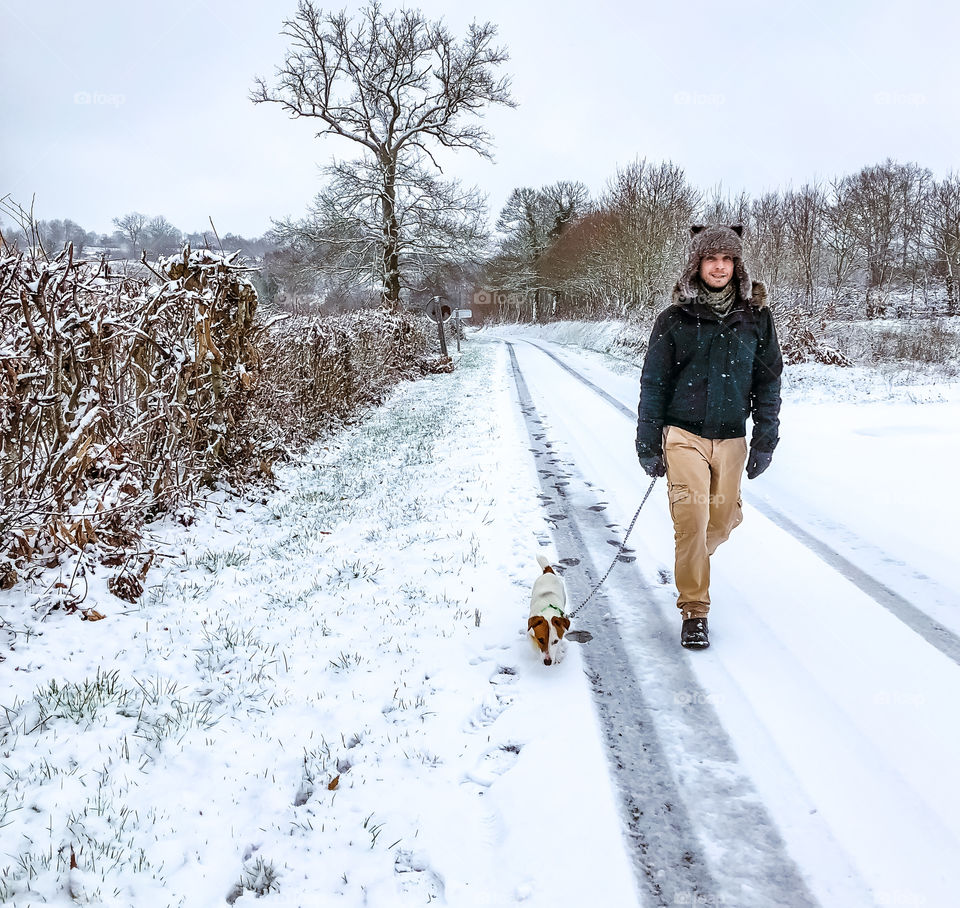 Dog walking on a snowy morning in rural France 