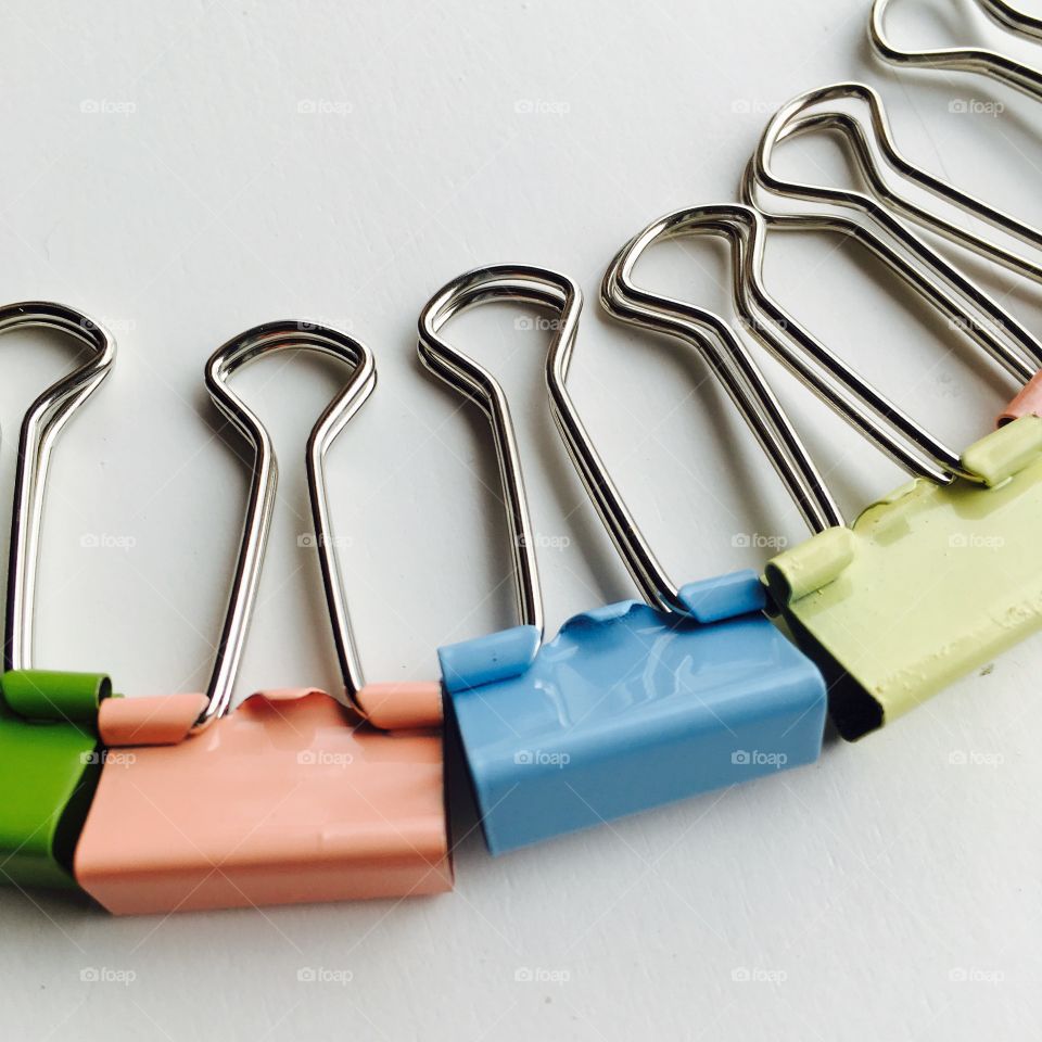 This is random , but very beautiful pastel paper clips on a white background . 
