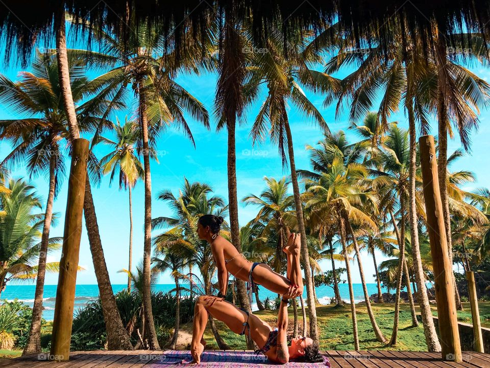 Acrobatic o the beach with my friend. scenery with coconut trees.
