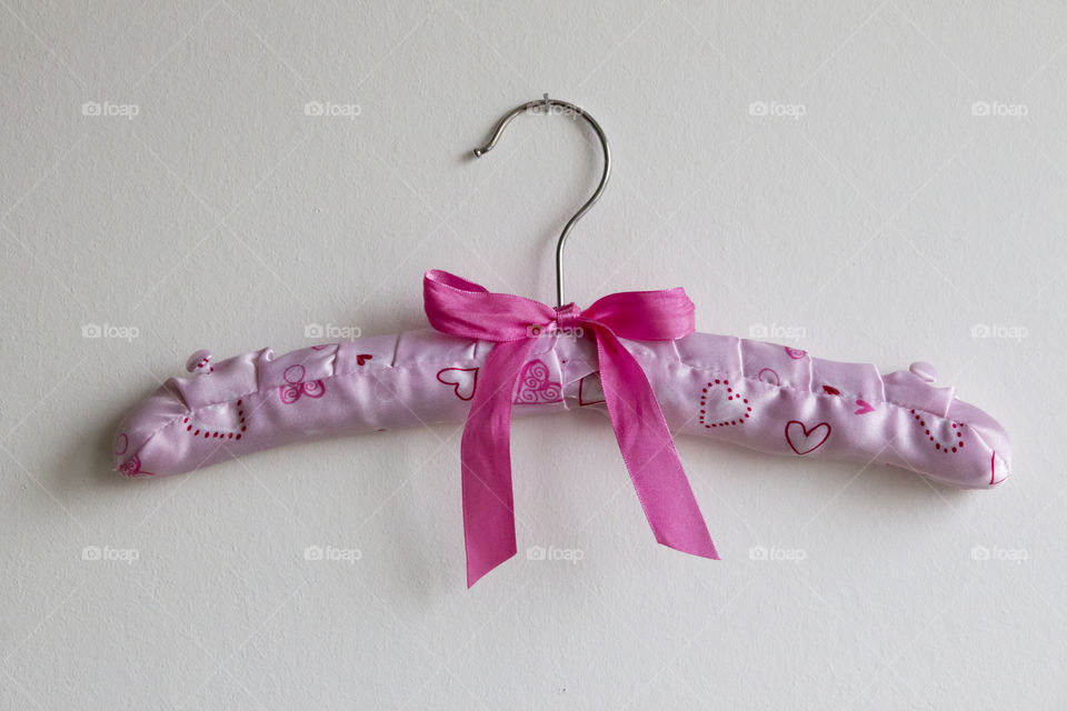 Pink hanger against white background