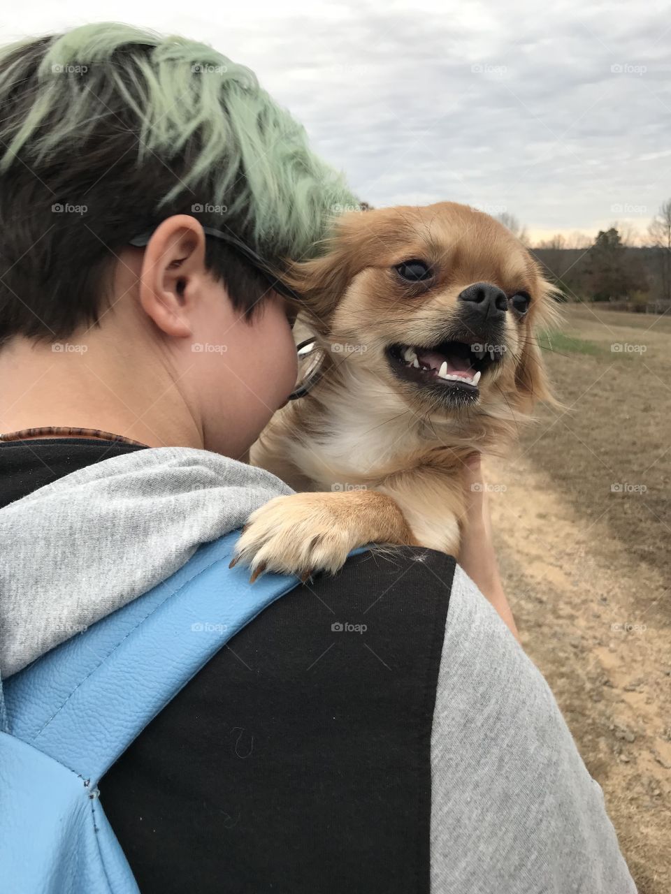Teen and puppy on shoulder