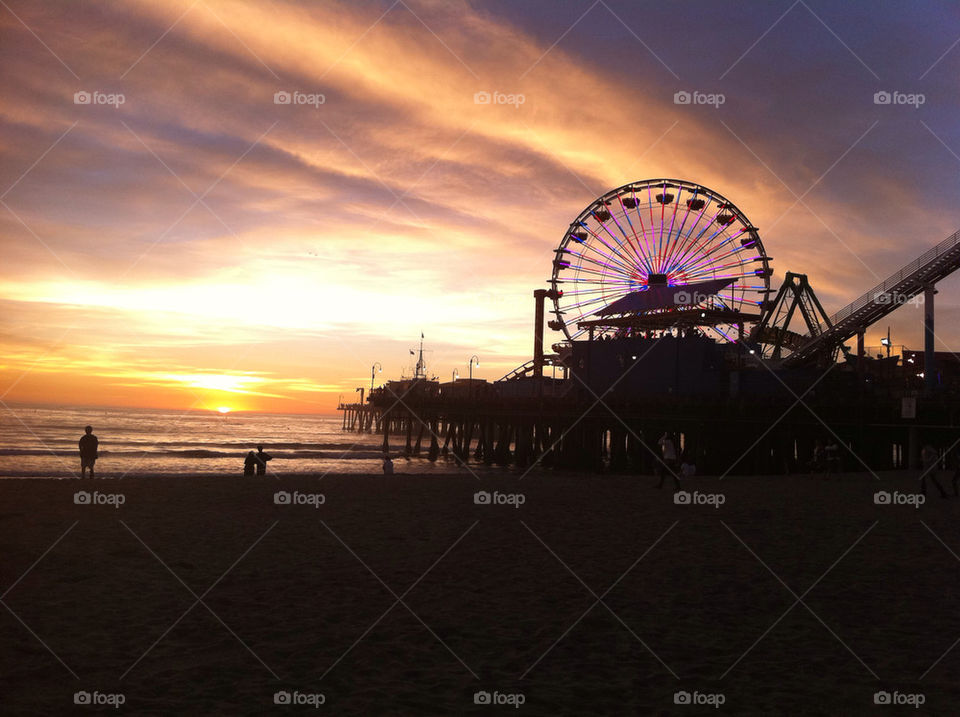 Santa Monica pier sunset. Sunset at the Santa Monica pier. Ferris wheel lights beginning to show. 