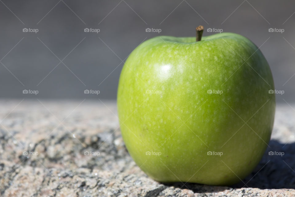 Green apple on the rock