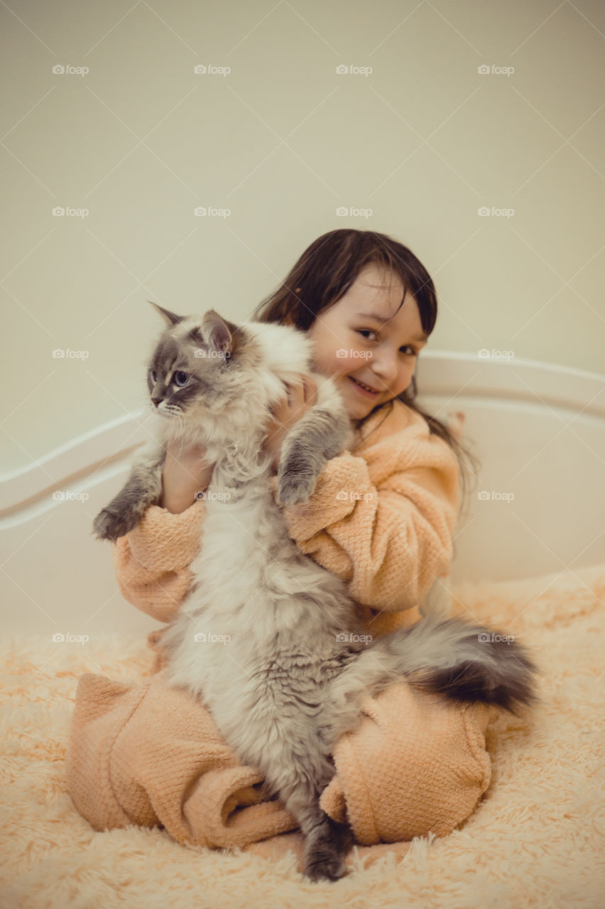 Little girl with Siberian cat