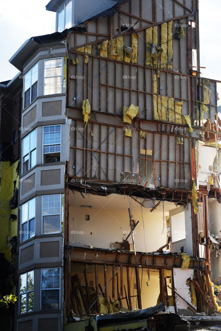 The inner framework of apartment building consisting a wooden beams, electrical wires, and all the fixings are exposed during extensive renovation work as a result of catastrophic structural damage.