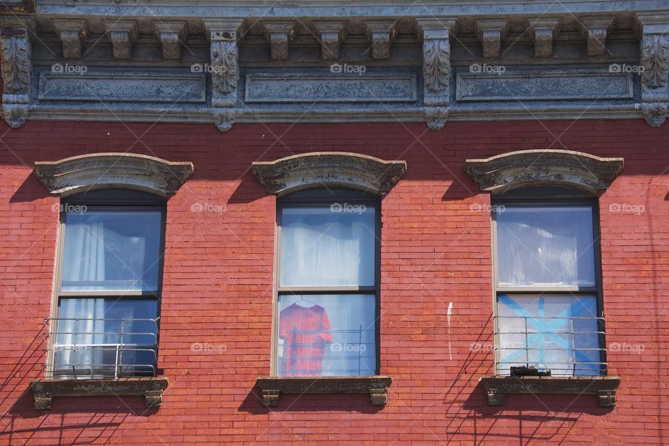 Three windows and architectural details of a building in  Brooklyn, New York City