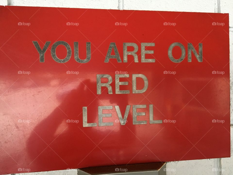 You are on red level sign with photographer reflection
