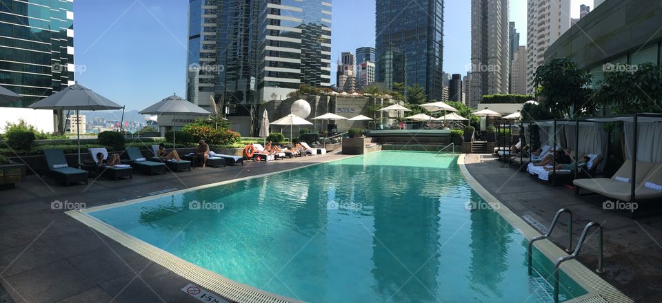 Hong Kong. A City bustling with the newness, business, and money, as well as old, traditional, struggling areas that represent days of old. Beautiful hotel pool in the heart of the city 