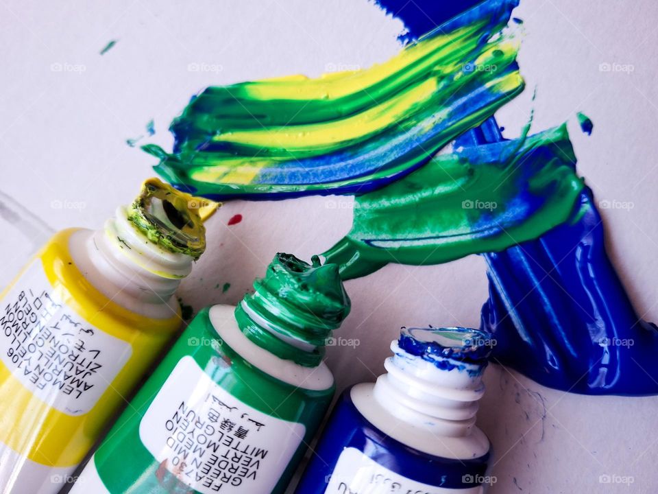green blue and yellow colors smeared on paper