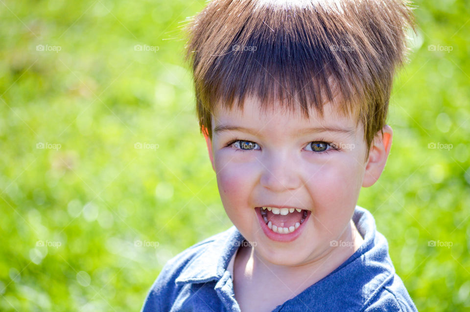 Portrait of a young toddler boy happy and smiling outdoors