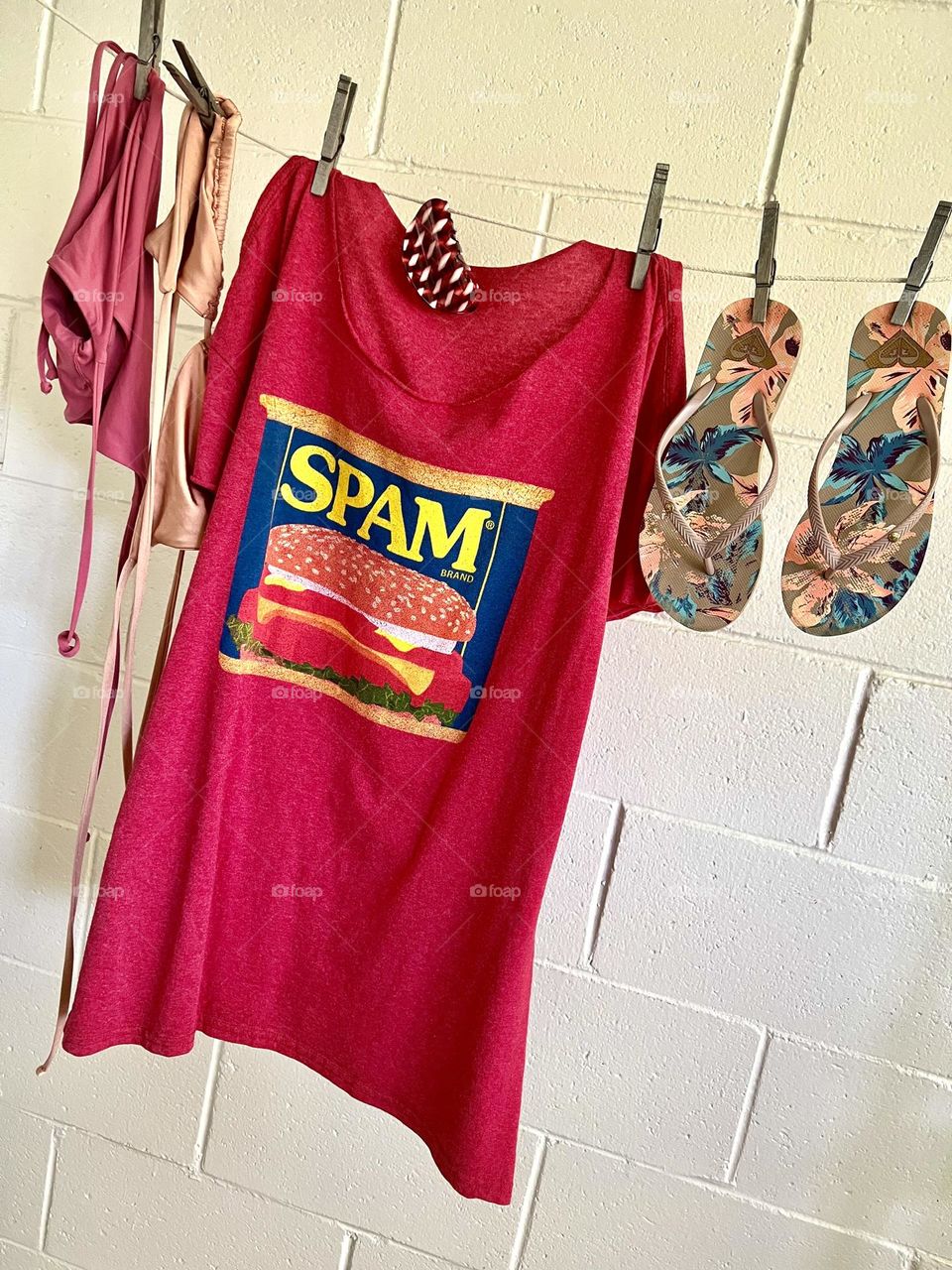 My fun-in-the-sun essentials - bikini that stays on in the waves, a pair of tropical patterned flip flops, my men’s XL “SPAM” T-shirt, and a pretty red and white plastic claw to hold beach hair in place