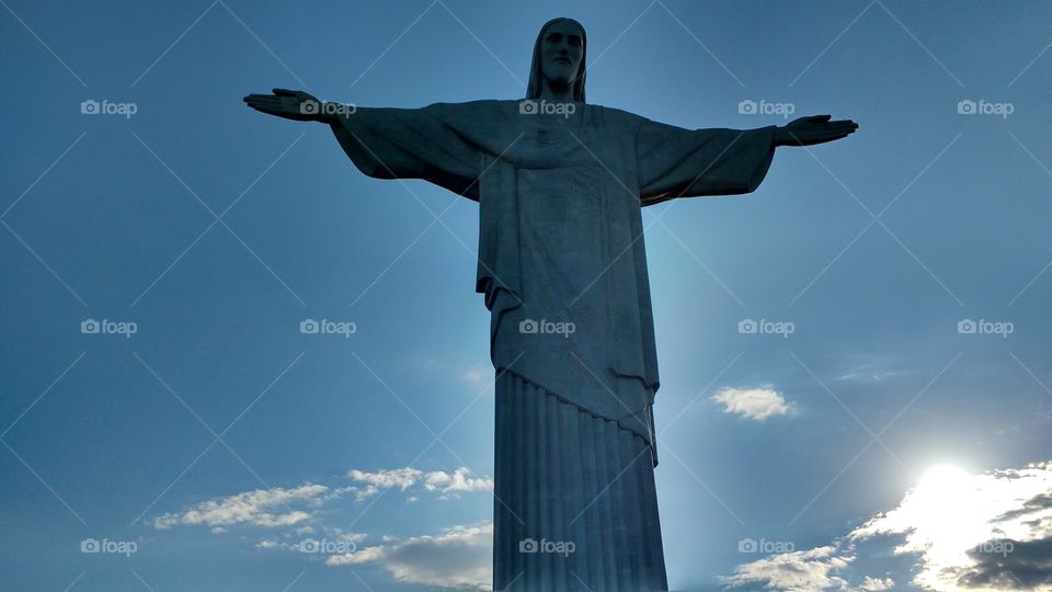 Cristo Redentor Corcovado Rio de Janeiro RJ Brasil
"Christ the Redeemer (Portuguese: Cristo Redentor, standard Brazilian Portuguese: [ˈkɾistu ʁedẽˈtoʁ], local dialect: [ˈkɾiɕtŭ̻ xe̞dẽ̞ˈtoɦ]) is an Art Deco statue of Jesus Christ in Rio de Janeiro, Brazil, created by French sculptor Paul Landowski and built by the Brazilian engineer Heitor da Silva Costa, in collaboration with the French engineer Albert Caquot. Romanian sculptor Gheorghe Leonida fashioned the face. The statue is 30 metres (98 ft) tall, not including its 8-metre (26 ft) pedestal, and its arms stretch 28 metres (92 ft) wide.
The statue weighs 635 metric tons (625 long, 700 short tons), and is located at the peak of the 700-metre (2,300 ft) Corcovado mountain in the Tijuca Forest National Park overlooking the city of Rio. A symbol of Christianity across the world, the statue has also become a cultural icon of both Rio de Janeiro and Brazil, and is listed as one of the New Seven Wonders of the World. It is made of reinforced concrete and soapstone, and was constructed between 1922 and 1931. "
Fonte: Wikipédia, acesso em 06/11/2016.
