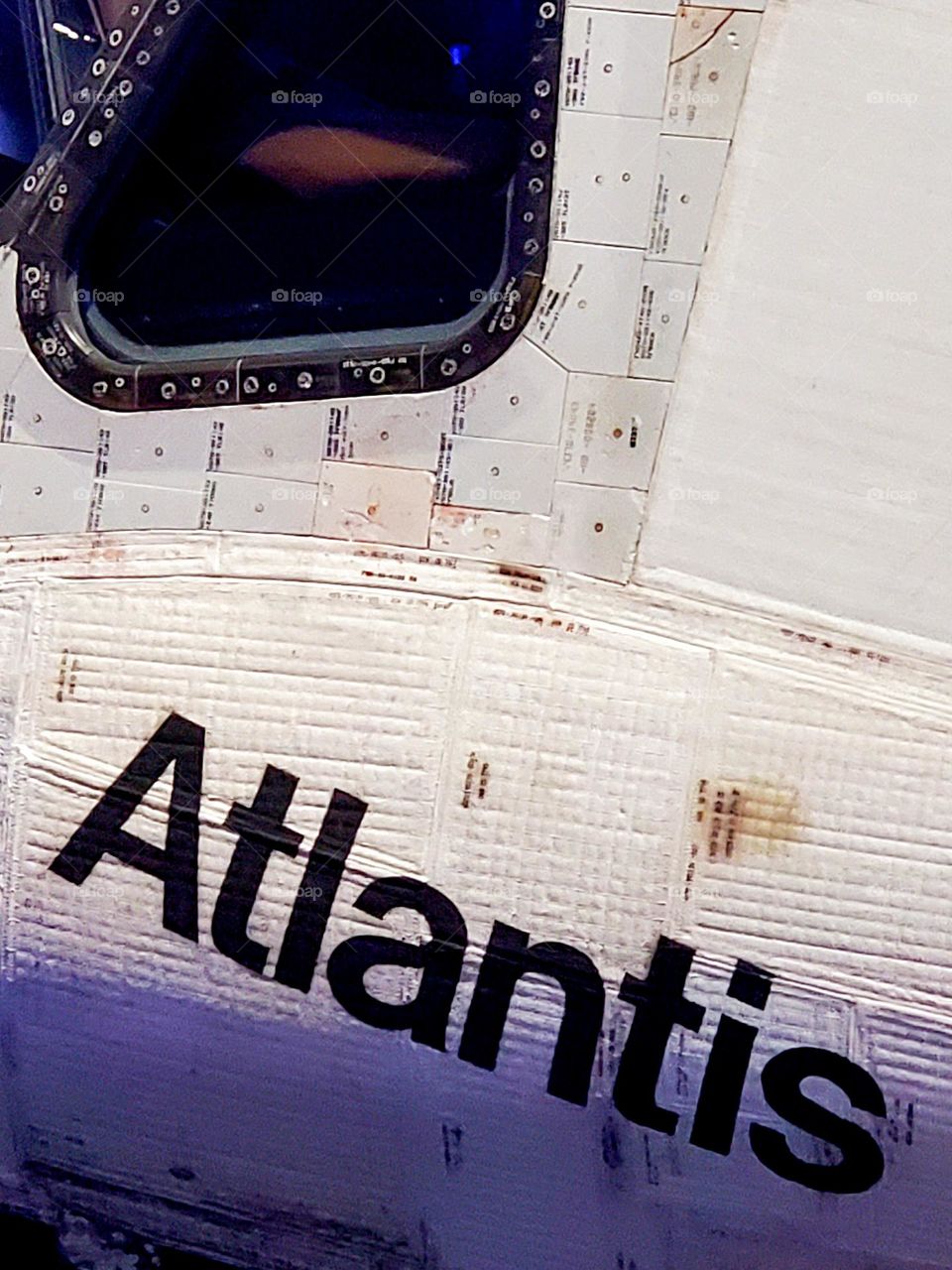 A closeup of the American Space Shuttle Atlantis near the pilots front window shows the white heat resistant tiles