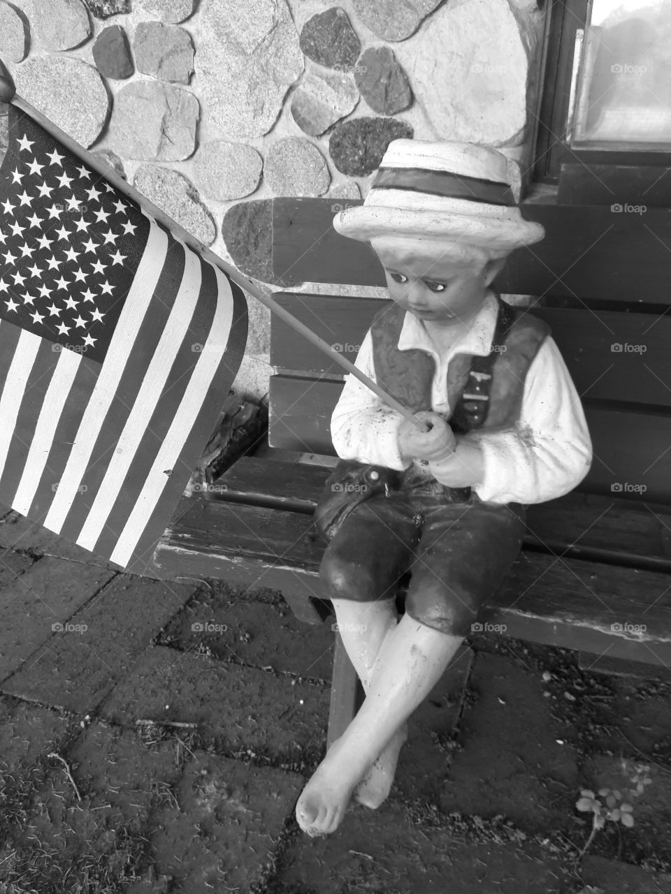 American Flag and little boy statue