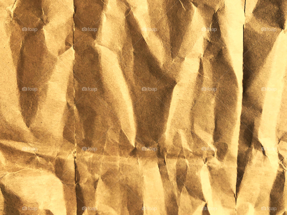 crumpled paper with dramatic yellow color in full frame, using as background
