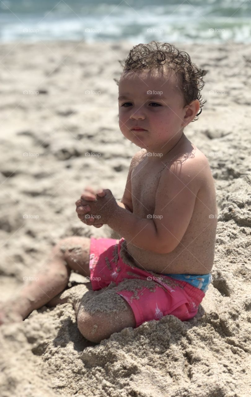 Boy in sand on beach 