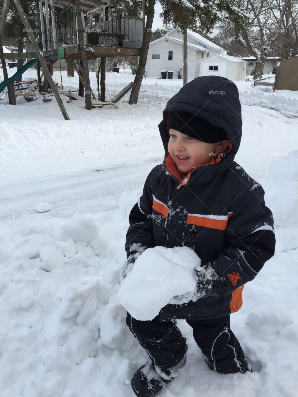 Cute boy playing in snow