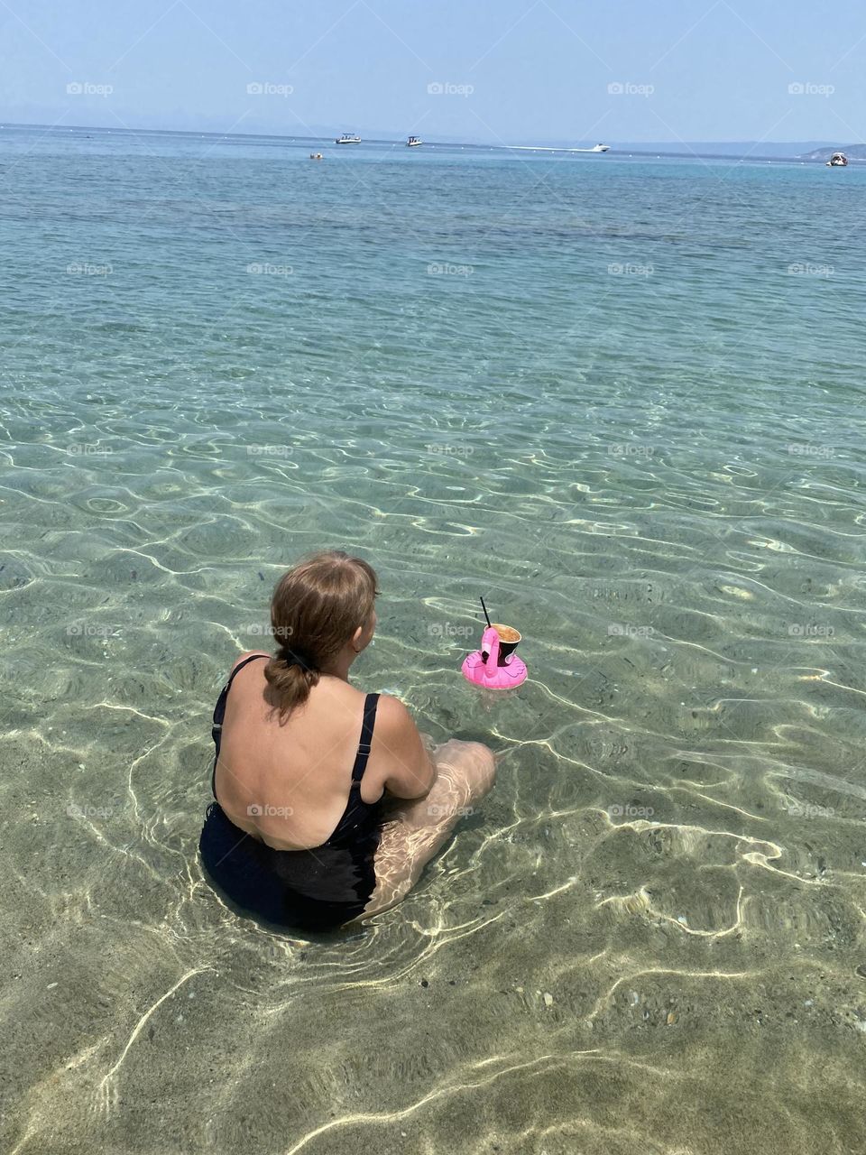 Having a frappe at the clear water of the sea