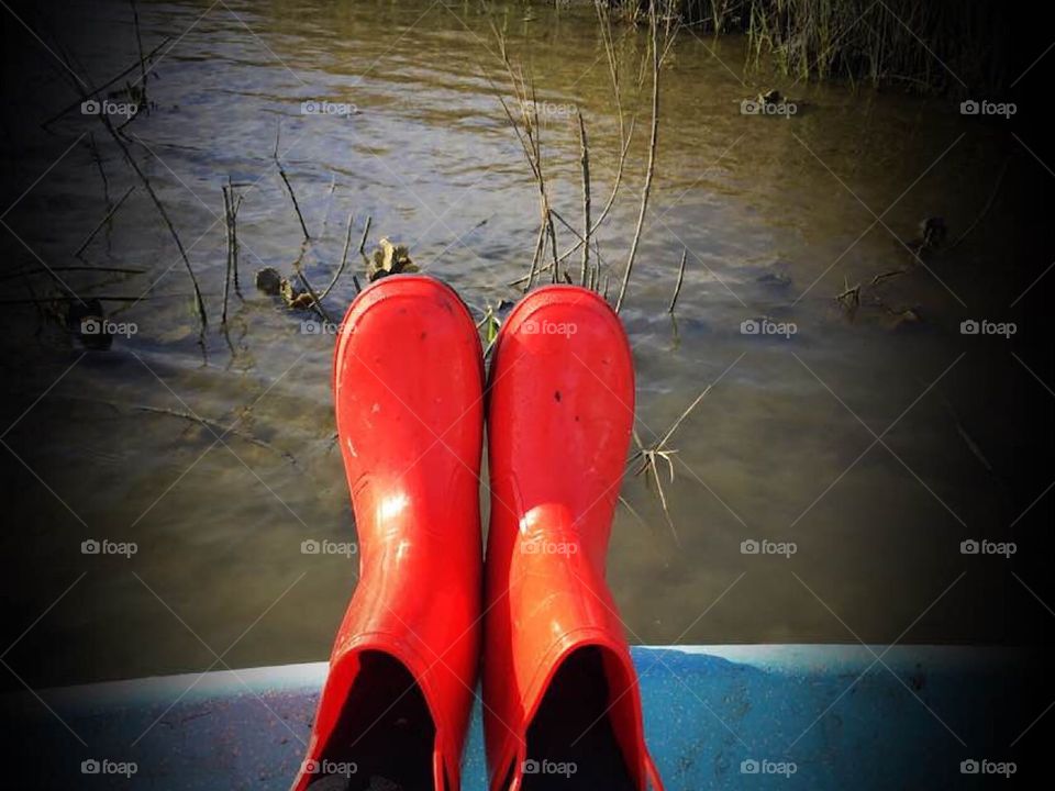 Oh just a woman on a boat with her red boots getting some salty oysters 