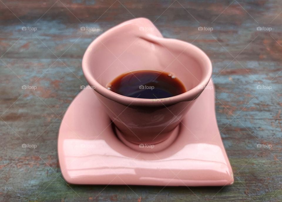 Black coffee in pink cup