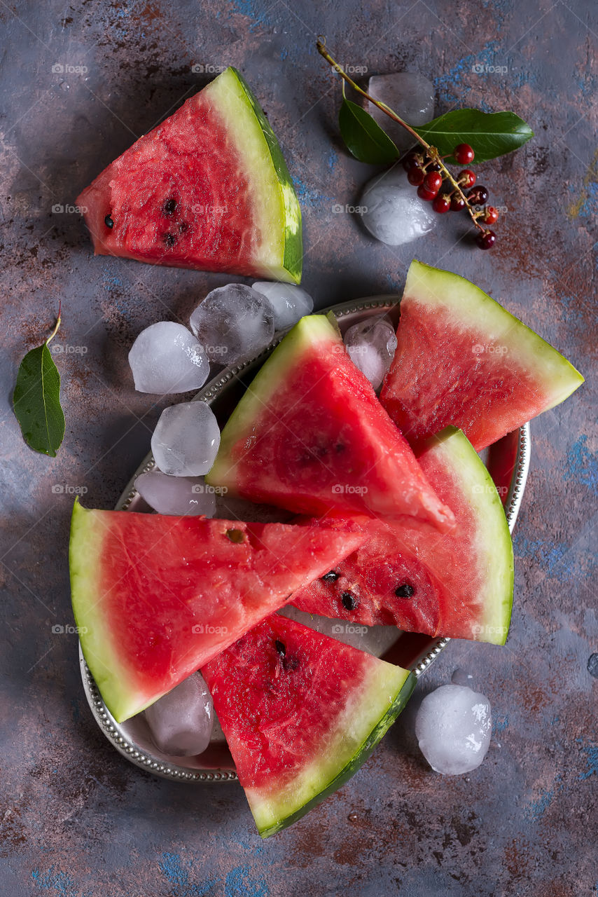 Watermelon with ice on a plate