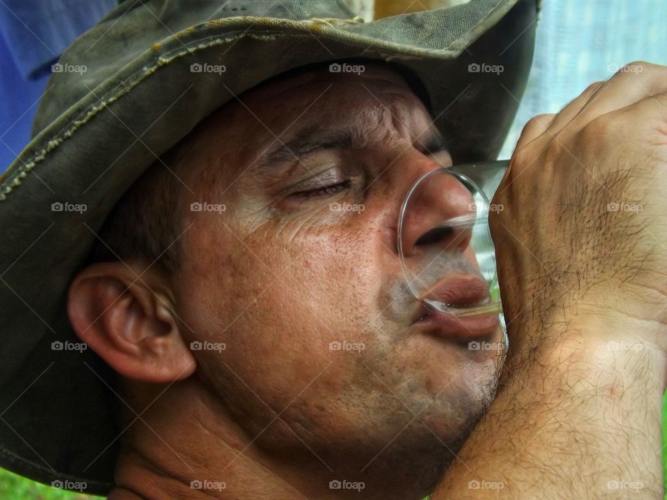 Man in a hat drinking beer