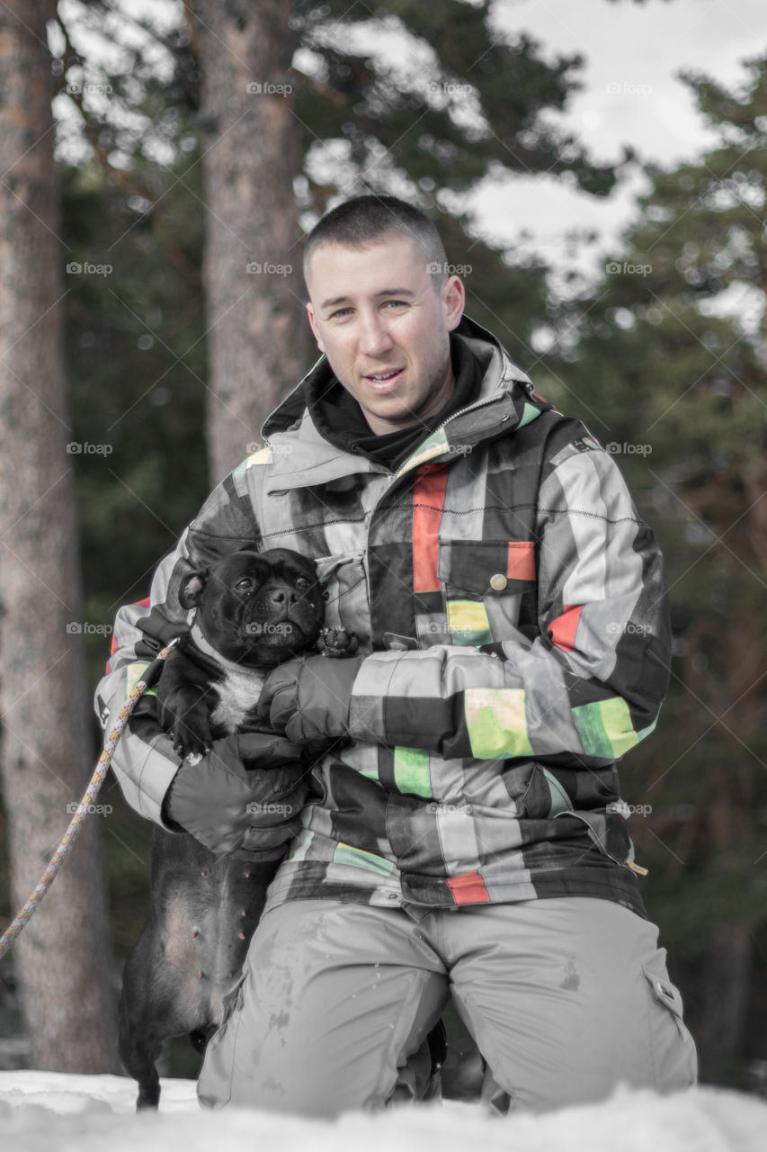 Boy with dog posing in the snow