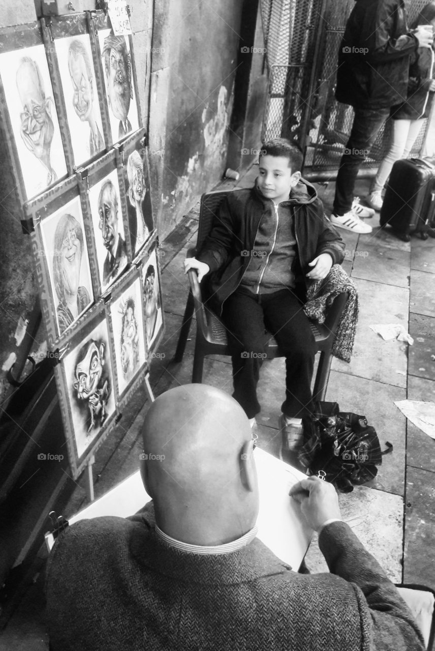 Rear view of a bald man drawing sketch