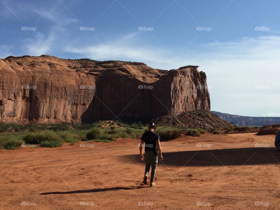 Man walks in the desert of the monument valley 