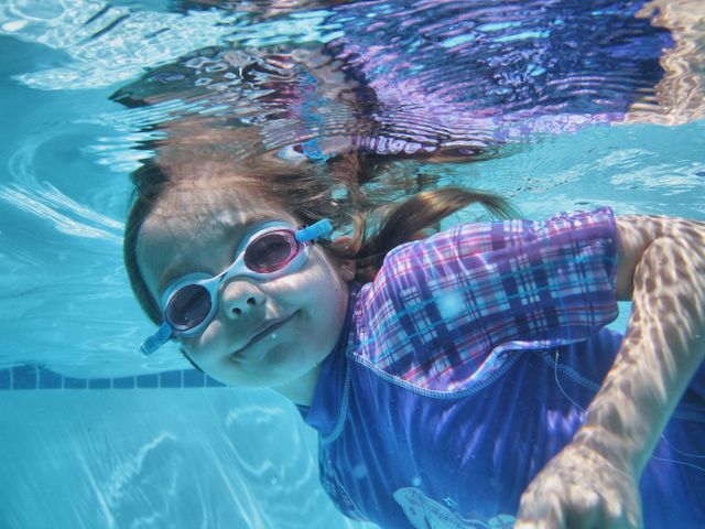 Girl swimming in swimming pool