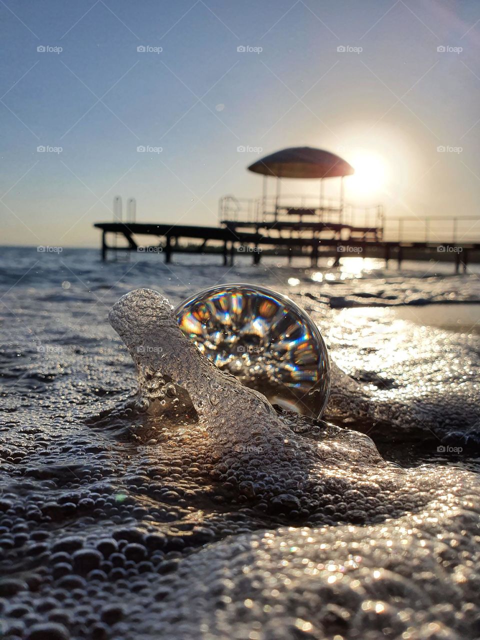 Creative Shot of a Lensball on Sea Shore