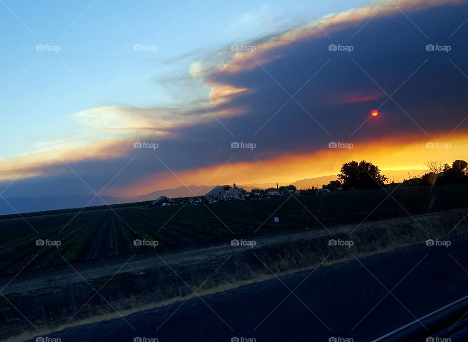 taken about 8pm on June 25th 2018 from HWY 5,  California. The sun is setting behind black smoke from a fire in Lake County.