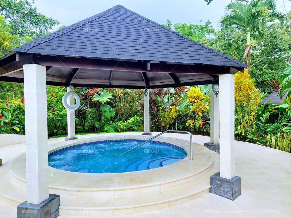 Small round pool jacuzzi in the open area.  Dominance geometric shapes: circle,  triangle, and  rectangle