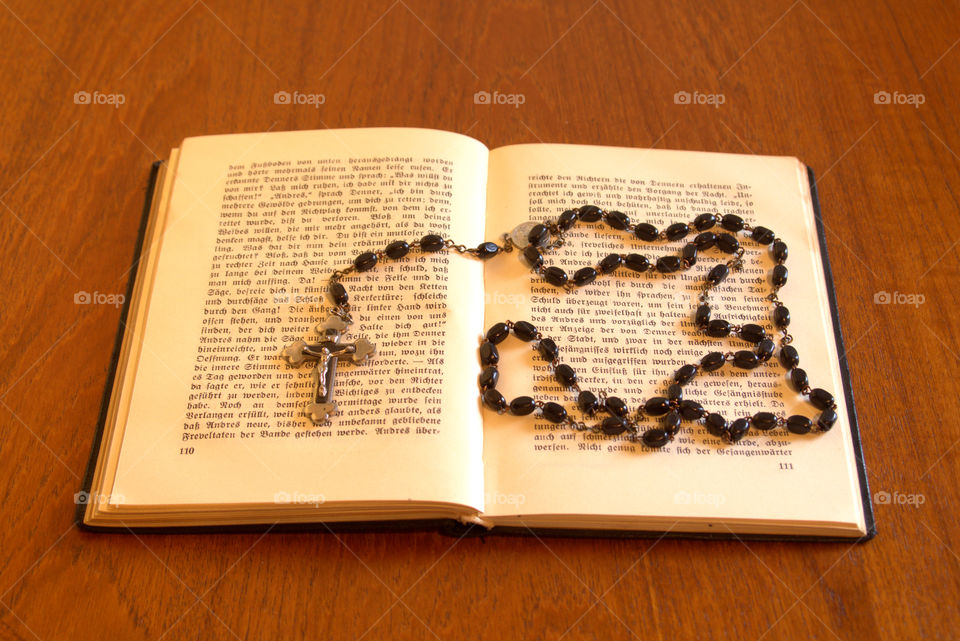 Old book with rosary